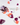 Aus einer geöffneten Flasche INAO by essence Clean Skin Community Edition Gummies verschütten sich violette und orangefarbene Gummibärchen auf einer weißen Fläche. Ein Etikett weist auf die Gummibärchen hin: „60 Stück für 1 Monat“ (deutsch).