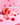 Eine durchsichtige Flasche INAO von essence Clean Skin x JUICY BOMB Gummies verschüttet leuchtend rote und pinke Nahrungsergänzungsmittel mit Biotin und Zink auf einer pinkfarbenen Oberfläche. Auf dem Etikett steht „60 Stück für 1 Monat“.
