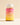 Eine Flasche INAO by essence Clean Skin Gummies mit weißem Verschluss und orangefarbenen Kapseln trägt ein rosa-gelbes Farbverlaufsetikett mit der Aufschrift „Clean Skin“ sowie Produktdetails in Deutsch und Englisch, die auf einer neutralen Oberfläche dargestellt sind.