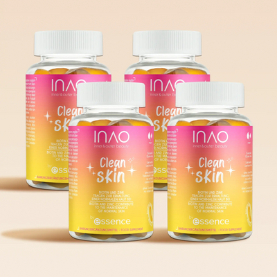 Vier Flaschen INAO by essence Clean Skin Gummies mit rosa, gelben und orangefarbenen Farbverlaufsetiketten werden auf hellbeigem Hintergrund präsentiert. Jede Flasche hat einen weißen Verschluss und einen klaren Markenaufdruck mit der Aufschrift Schutz und Probiotika.