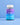 Eine Flasche INAO von essence Dream & Chill Gummies mit einem blauen und violetten Etikett steht aufrecht vor einem hellblauen Hintergrund.