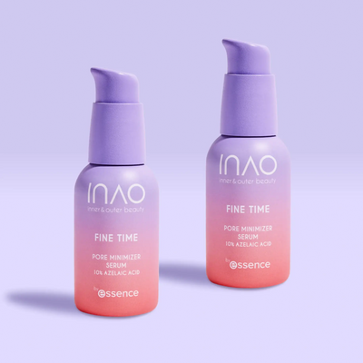 Zwei Flaschen INAO by essence Fine Time Pore Minimizer Serum mit 10 % Azelainsäure für unreine Haut in Rosa und Lila mit Farbverlauf stehen auf einer hellvioletten Oberfläche vor einem zartvioletten Hintergrund.