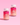Zwei Flaschen Hair YEAH! Gummies von INAO by essence sind auf einer rosa Fläche mit rosa Farbverlauf abgebildet. Jede Flasche hat einen weißen Deckel und ein leuchtend pink-oranges Etikett, das die Hauptbestandteile Biotin und Zink auf der Verpackung hervorhebt.