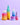 Ein Set aus fünf farbenfrohen Hautpflegeprodukten von INAO by essence, genannt „Get Stronger Sparset“, wird vor einem violetten Hintergrund mit Flaschen und Tiegeln mit den Aufschriften „Clean Skin“, „Feel Pure“, „Dewy Drop“, „Barrier Me“ und „Fine Time“ präsentiert.