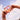 Zwei Hände mit bunten Ringen und Armbändern halten eine rosa-orange Flasche mit der Aufschrift „NYO YOUTH SERUM“ vor einem blauen Himmel mit vereinzelten Wolken.