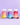 Drei farbenfrohe Flaschen mit INAO by essence Clean Skin Gummies, Dream & Chill und Hair Yeah sind vor einem violetten Hintergrund angeordnet, jeweils mit passenden Haut Vitamine Gummibonbons davor.