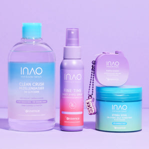 Auf einem violetten Hintergrund sind vier INAO by essence New Drop Sparset Hautpflegeprodukte aufgereiht - Micellarwasser für sanfte Reinigung, Spray, Creme und ein runder Behälter - alle in pastellblauen, violetten und grünen Verpackungen.